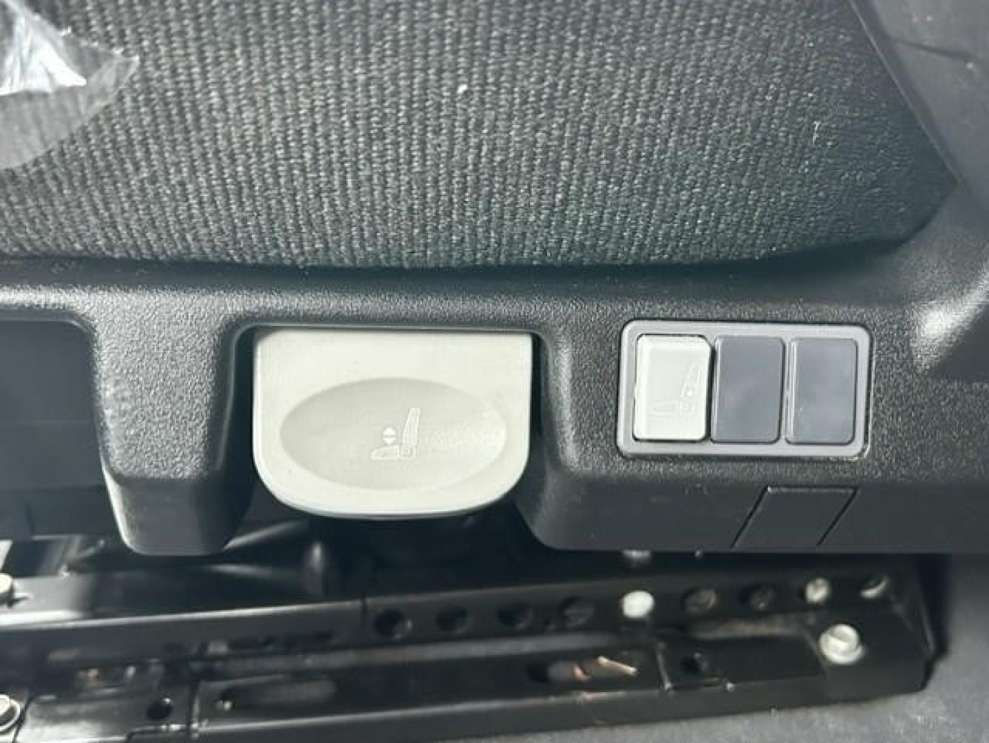 Freightliner Cascadia cab area showing seat adjustment and control switches.
