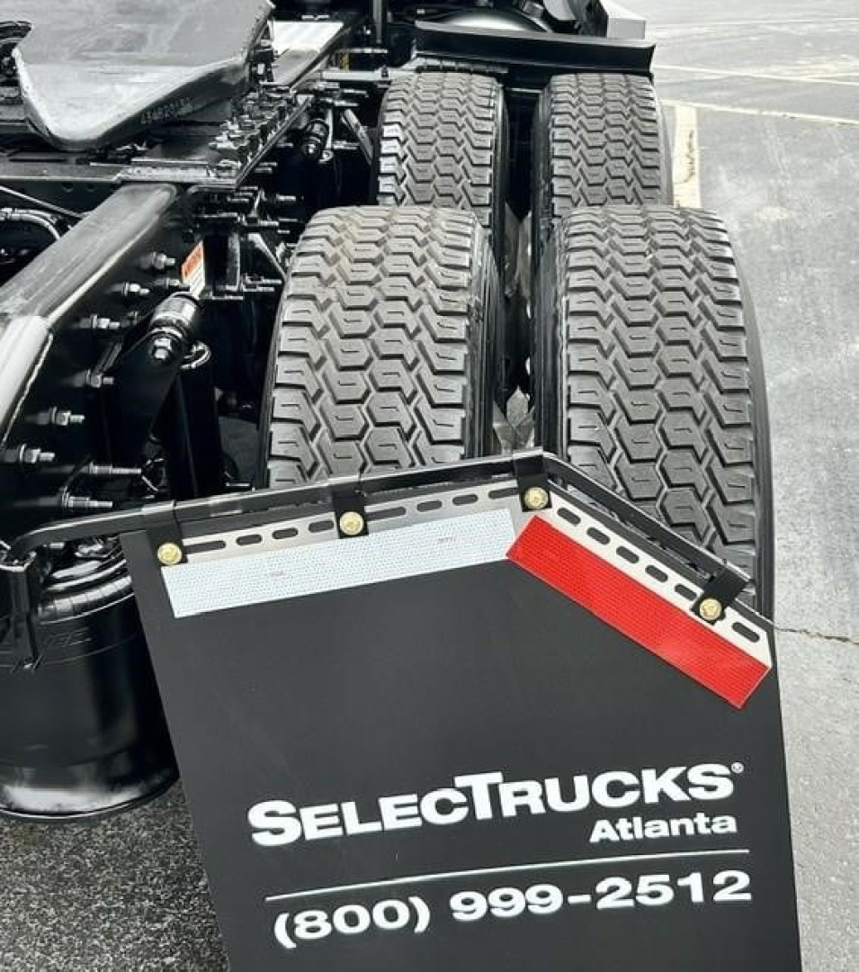 Freightliner Cascadia truck rear dual steer tires and trailing equipment with SelectTrucks Atlanta license plate bracket and contact number (800) 999-2512.