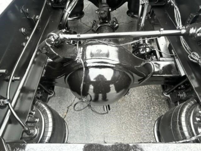 Rear axle and differential housing of a Freightliner Cascadia 126 chassis showing suspension components and driveshaft framing.