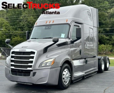 Freightliner Cascadia 126 semi-truck in a dealership lot showing the cab and front grille.