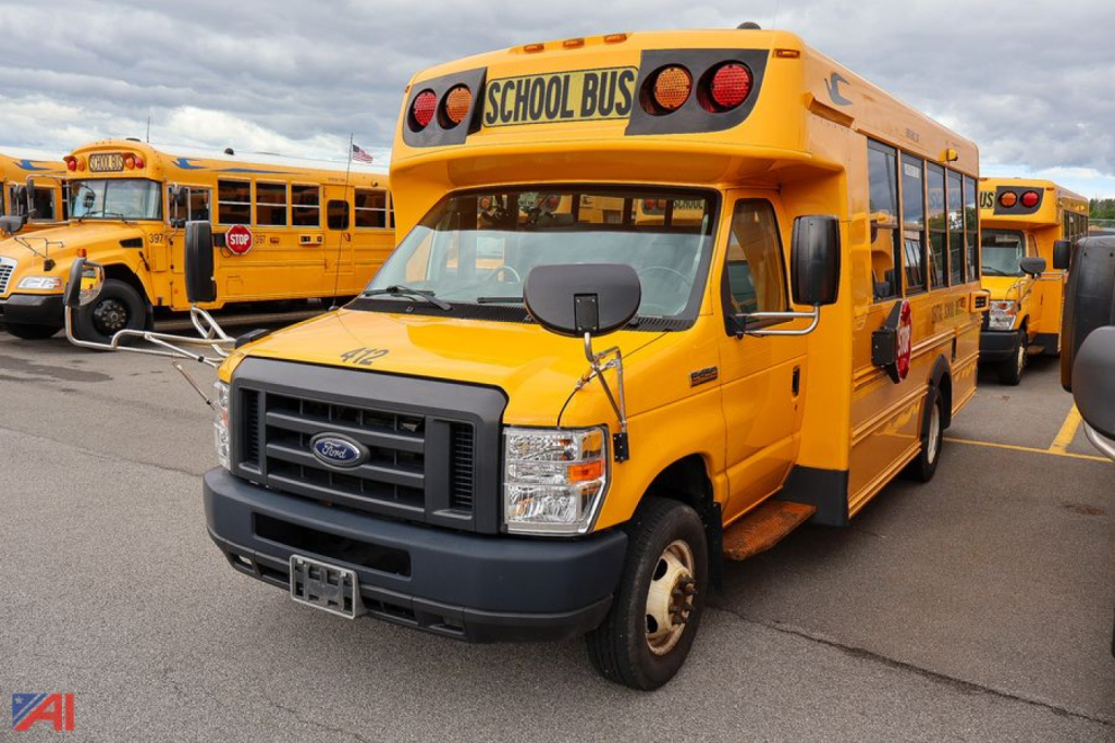 2019 Ford Blue Bird E-Series school bus, front view with 'SCHOOL BUS' sign, yellow body and black grille.