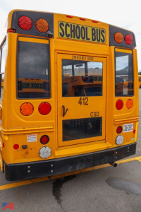 Ford Blue Bird school bus rear view showing SCHOOL BUS sign, emergency exit, tail lights, and body number 412.