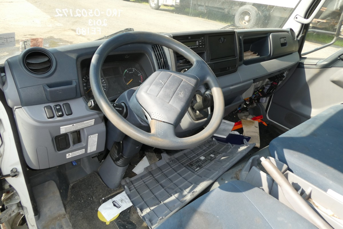 Cab and chassis truck interior showing steering wheel, dashboard, and pedals.