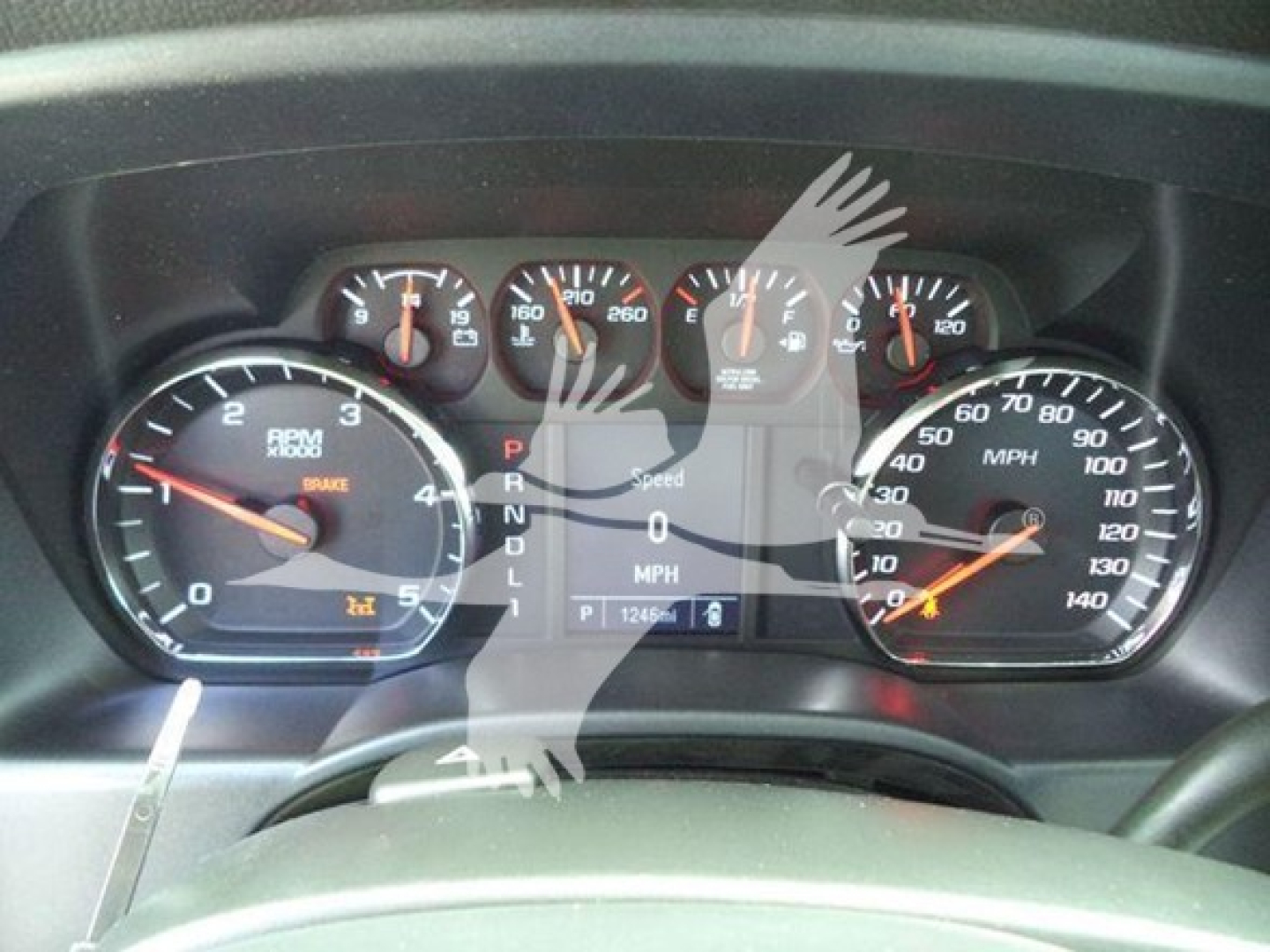 Dashboard view of a truck showing analog gauges including RPM, speedometer, fuel, and warning icons