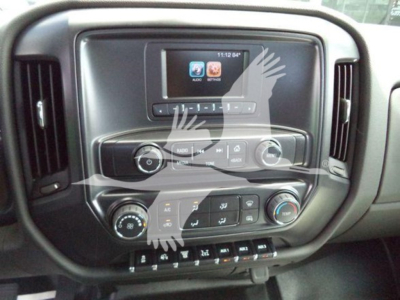 Dashboard of a truck with touchscreen display and climate controls visible; includes buttons and knobs on center console.
