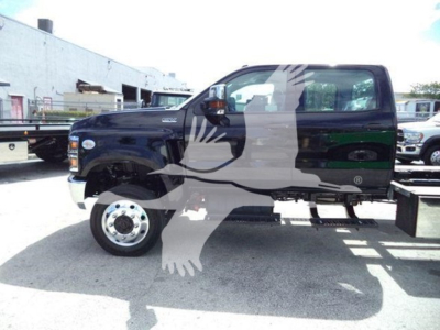 2023 International Cv truck side view showing cab and wheel; no visible text legible other than faint dealership watermark silhouette.