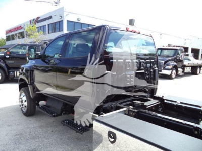 2023 International CV Rollback truck cab side view showing crew cab, black paint, side steps, and chassis frame.