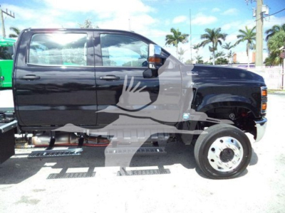 Black International CV Series rollback truck in side view with white decals; visible text includes none legible; side steps and rear duals; a watermark graphic across the middle.