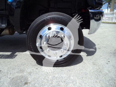 Truck wheel with tire showing markings: 225/70R22.5 on the sidewall; shiny wheel with lug nuts and hub; partial view of fender and undercarriage.