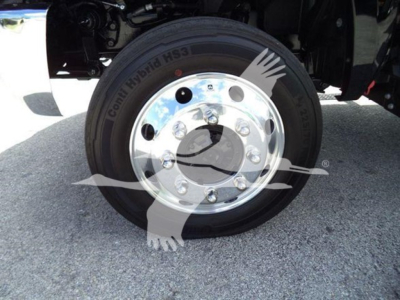Truck wheel with chrome dual wheel hub and tire showing Continental hybrid H53 label and wheel studs.