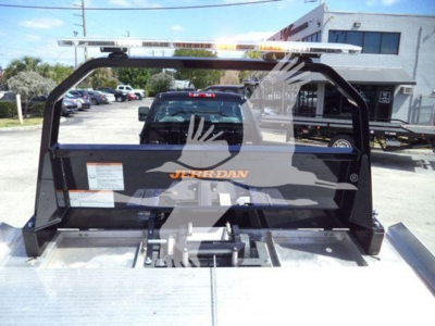 Truck bed view showing JERR-DAN rollback equipment mounted on a flatbed with a light bar and control mechanism.