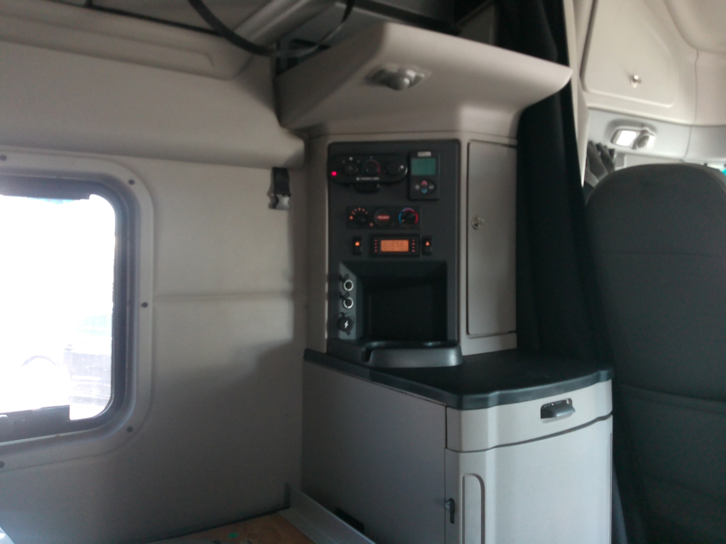 Peterbilt 579 interior cab area showing control panel and storage with drawers
