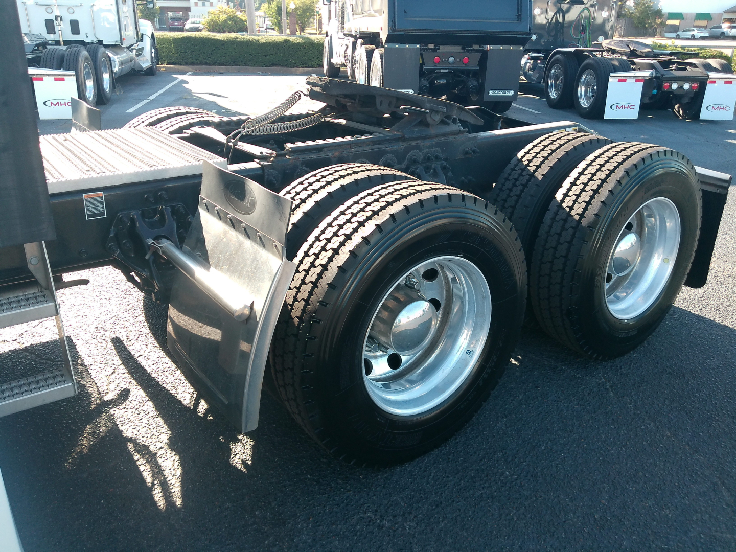 Peterbilt 579 rear dual rear axles and fifth wheel showing tires and suspension components.