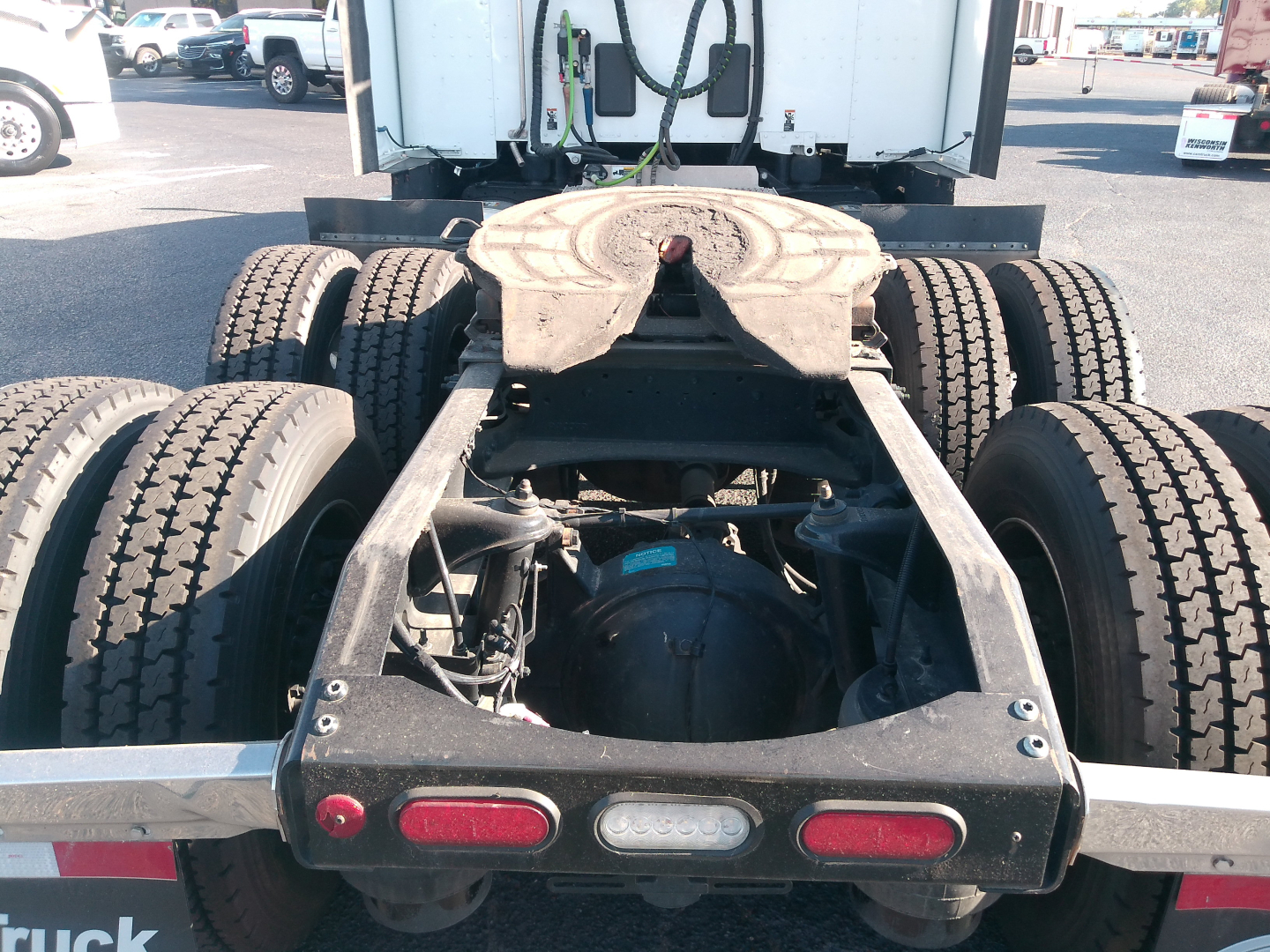 Peterbilt 579 chassis and rear axle view showing fifth-wheel hitch, dual rear axles, and taillights.
