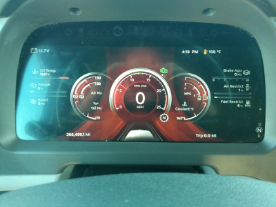 Peterbilt 579 digital instrument cluster display showing various gauges and readouts, including speedometer, fuel, oil temperature, and engine metrics.