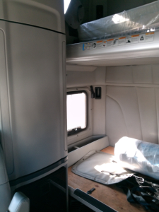 Peterbilt 579 truck interior cargo area with sleeper, storage compartment, and window visible.