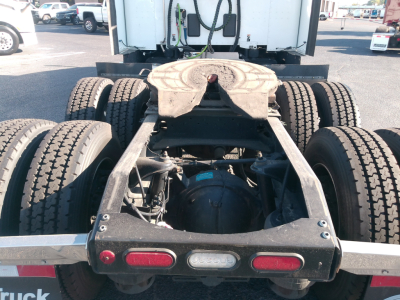 Peterbilt 579 chassis and rear axle view showing fifth-wheel hitch, dual rear axles, and taillights.