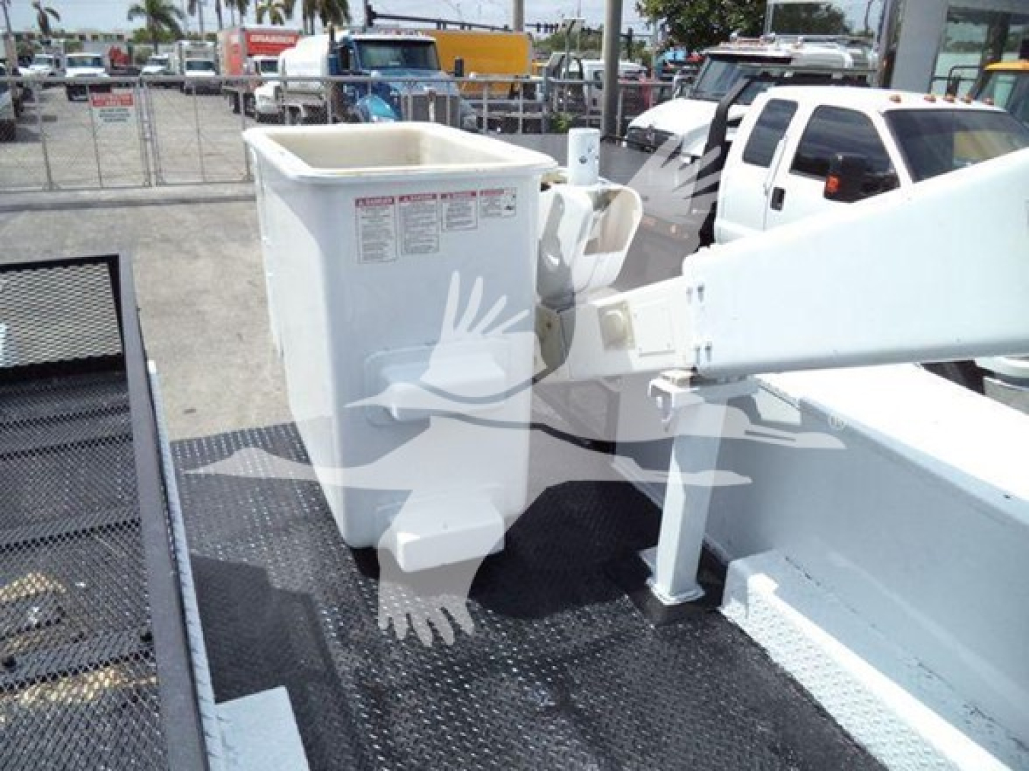 Versalift VST40i crane bucket and arm in a compact side view showing a white hydraulic platform and support structure.