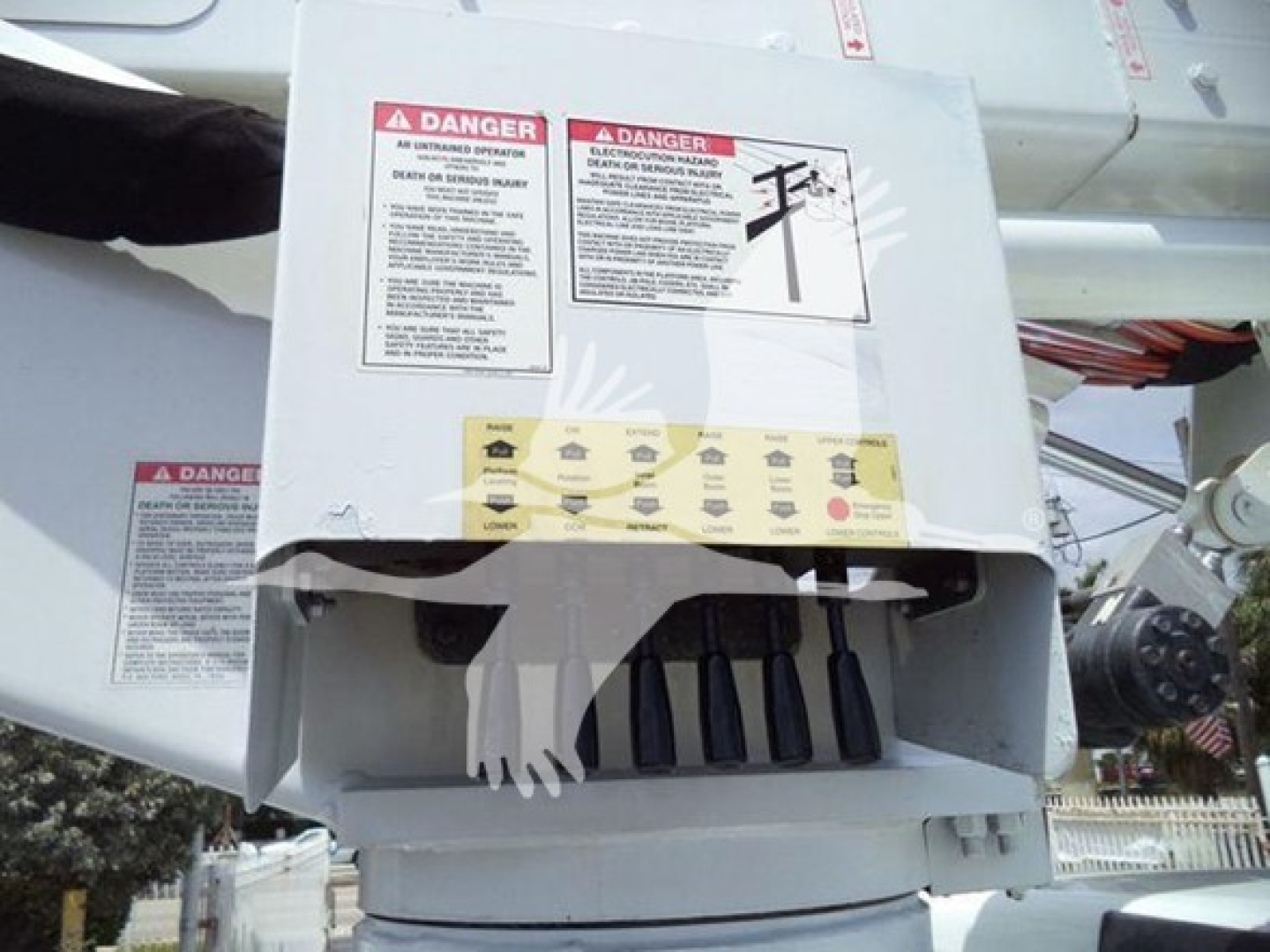 Versalift VST40i crane control box with warning labels and safety decals visible on the exterior.