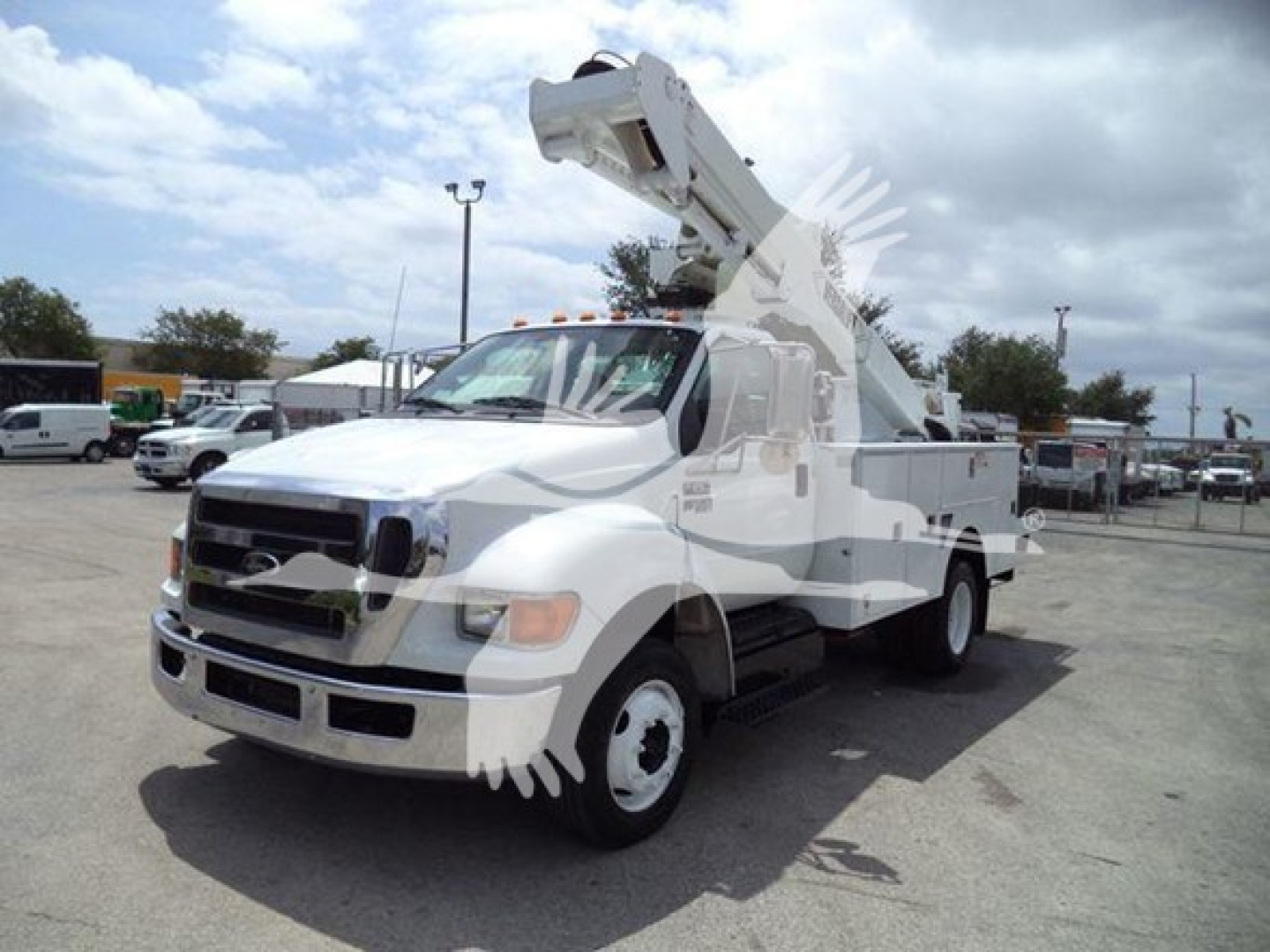 Versalift VST40i crane truck in-service showing boom lift extended on white utility truck side-view.