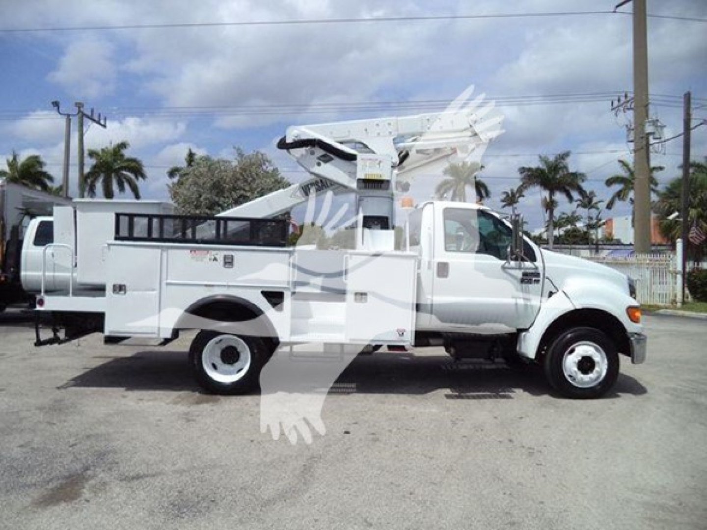 Versalift VST40i crane mounted on white utility truck with bucket and outriggers visible.