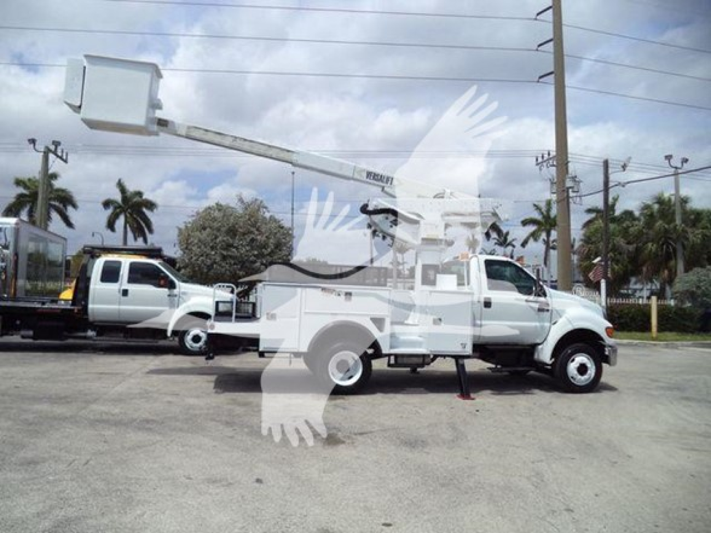 Versalift VST40i crane mounted on a utility truck with extended boom and bucket in serviceable condition.