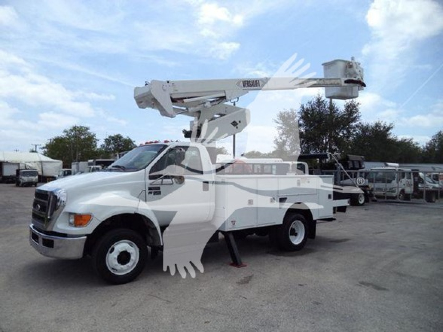 Versalift VST40i bucket truck in-service view showing hydraulic boom and bucket at full extension on a white truck chassis.