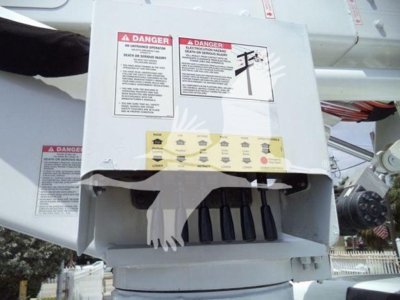 Versalift VST40i crane control box with warning labels and safety decals visible on the exterior.