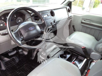 Interior view of a Ford-based Versalift VST40i crane cab showing steering wheel, dash, center console, and front seats.