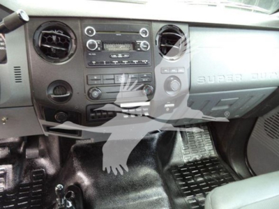 Interior of Versalift vehicle showing dashboard with stereo, vents, and controls; front passenger area visible