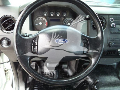 Versalift VST40i crane interior showing Ford steering wheel and dashboard gauges