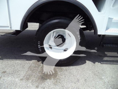Versalift VST40i crane equipment wheel and tire close-up view with white wheel cover and side of crane body.