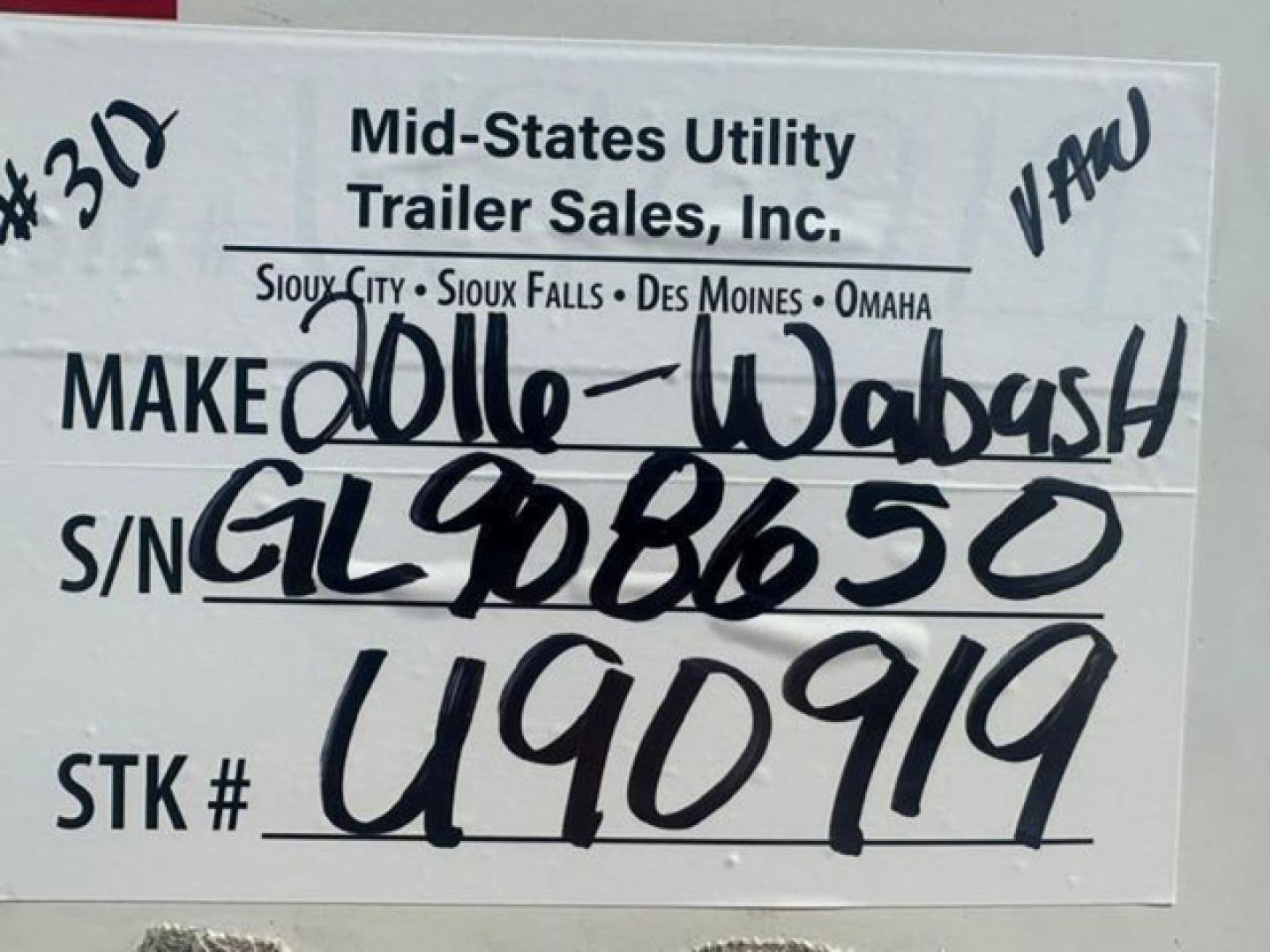 Trailer sign showing company name Mid-States Utility Trailer Sales, Inc. with location list and handwritten details: MAKE 2016-Wabash, S/N GL908650, STK # U90919. VIN 1JJV532D7GL908650, stock number U90919.
