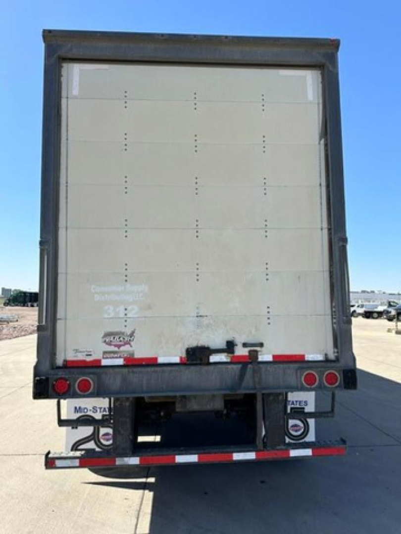 Back view of a 2016 Wabash van trailer showing rear doors, taillights, and bumper with reflectors.