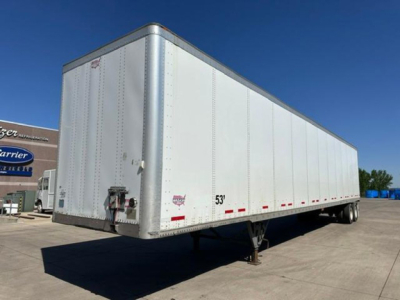Trailer side view showing a white 53' Wabash van trailer with landing gear and rear doors. Visible markings include a small label near the front and 53' length text.