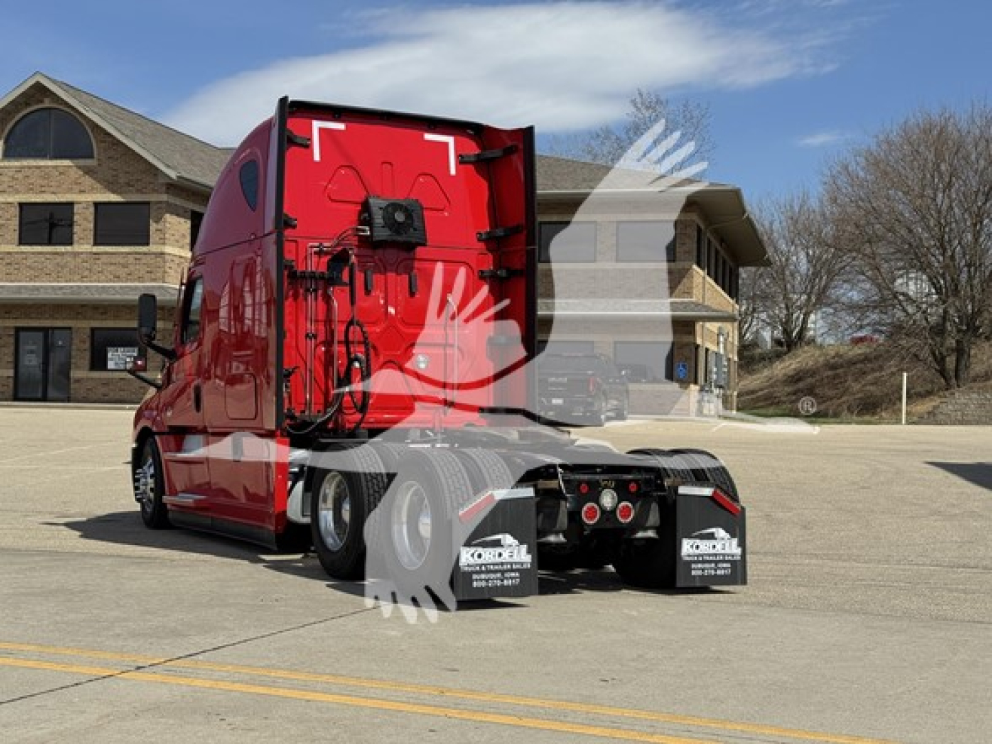 Freightliner Cascadia 126 sleeper truck rear view showing red cab with trailer connection area and rear mud flaps.