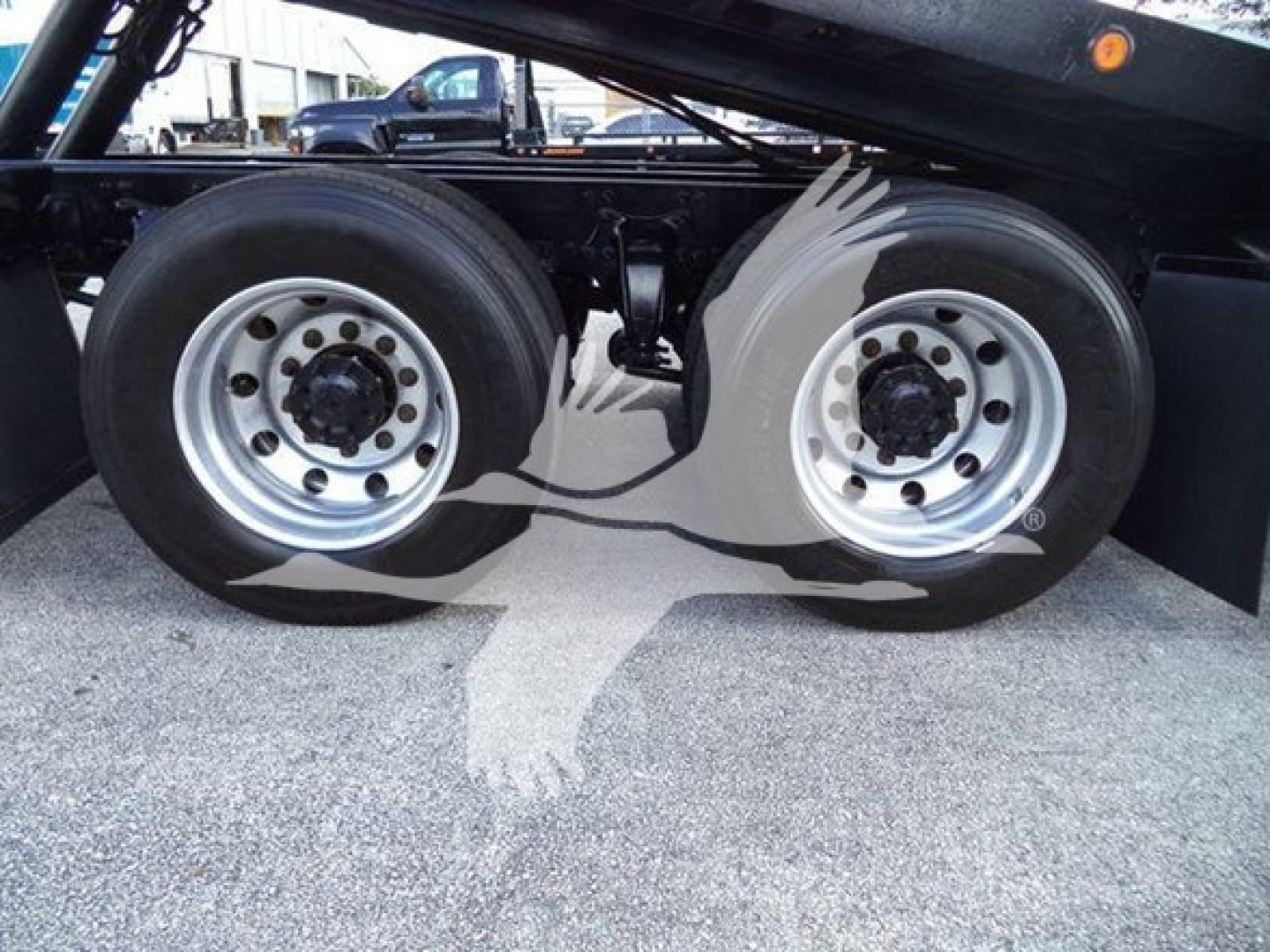 Freightliner M2 106 side view showing dual rear wheels and undercarriage components.