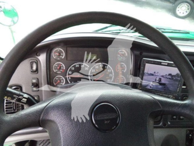 Truck cabin dashboard view of a 2015 Freightliner M2 106 with steering wheel and instrument cluster