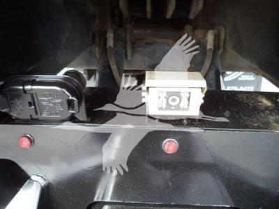 Truck electrical/connectors and hitch area on Freightliner M2 106 rollback showing 12V accessory plug and square electrical module.