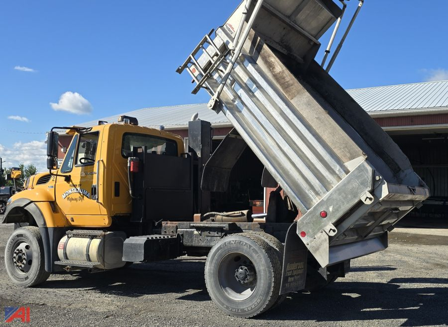 Side view of a yellow 2013 International SA537 WorkStar dump truck with its bed raised, showing the cab, exhaust, and front wheel.