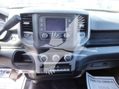 Truck cockpit showing center touchscreen, climate controls, and gear selector inRam 5500 cab interior.