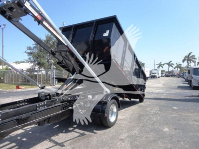 Ram 5500 dump truck body in black with raised bed and rear hitch, side view showing suspension and wheel.