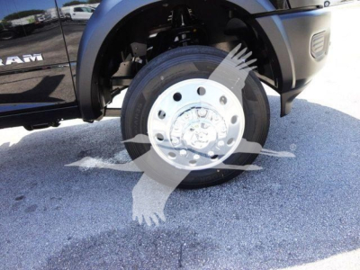 Ram 5500 front wheel well view showing wheel and hub with partial Ram badge; no full drivetrain text visible.