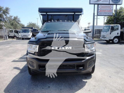 Front view of a 2024 Ram 5500 HD rolloff truck showing bold grille with RAM emblem and dark bumper.