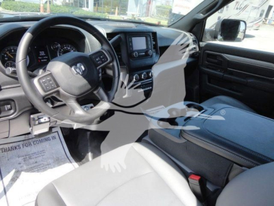 Ram 5500 HD interior showing steering wheel, dashboard, center touchscreen, and front seats.