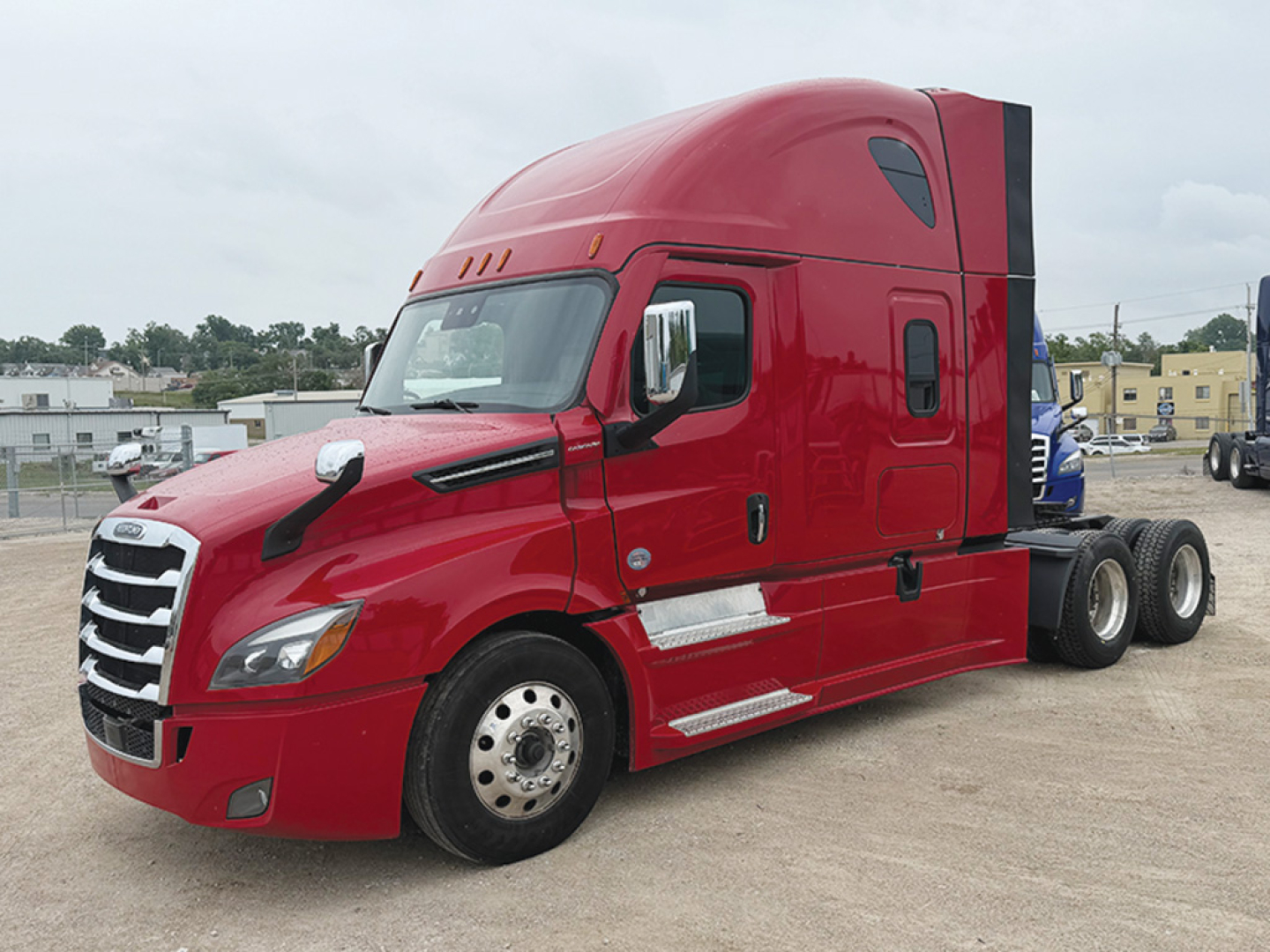 Red Freightliner Cascadia126 sleeper tractor cab profile with dual rear axles and chrome steps, stock number 560388, visible side windows and aerodynamic mirrors.