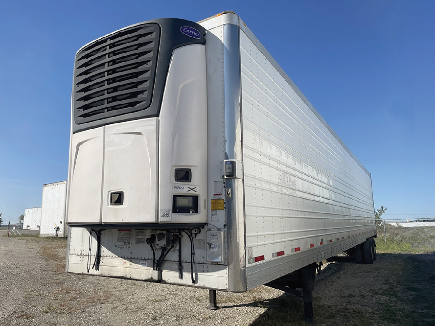 Utility reefer trailer with front refrigeration unit and silver side panels, 2020 model year, visible VIN tag area and support legs.