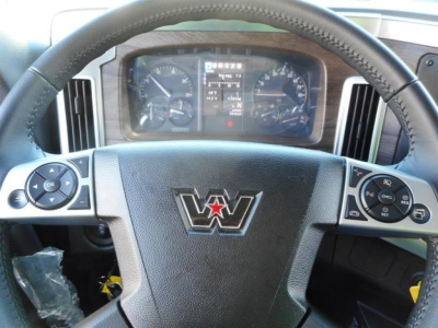 Steering wheel and dashboard of a Western Star truck cab showing instrument cluster and steering wheel with control buttons.