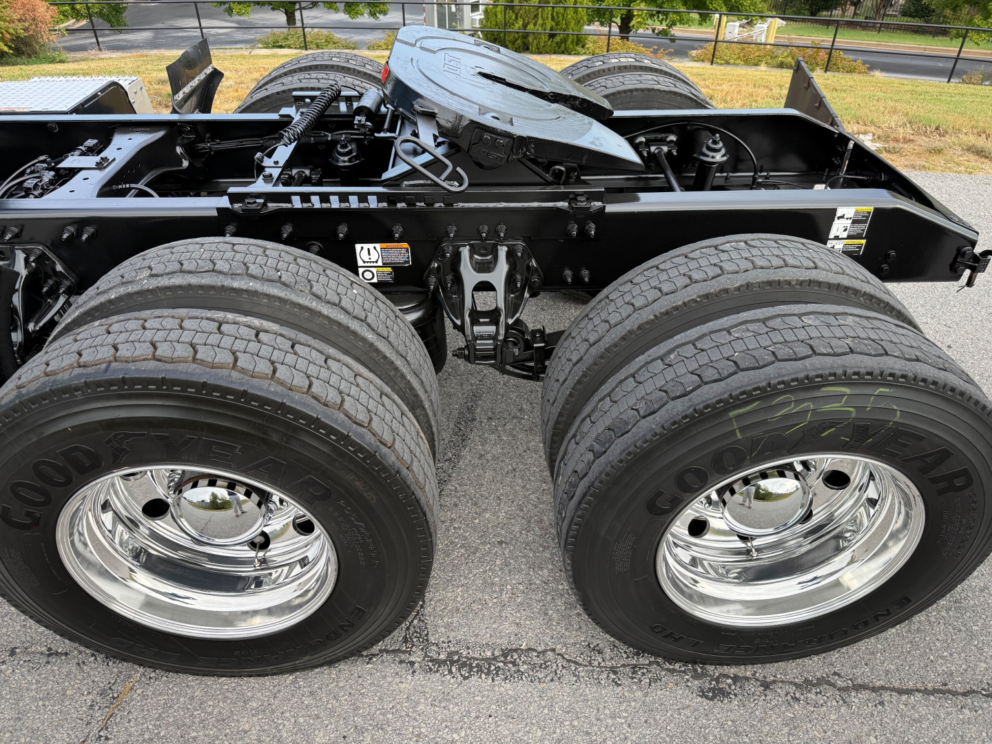 Peterbilt 579 chassis and dual rear wheels showing tires and chrome rims; fifth wheel mounting area and air lines visible.