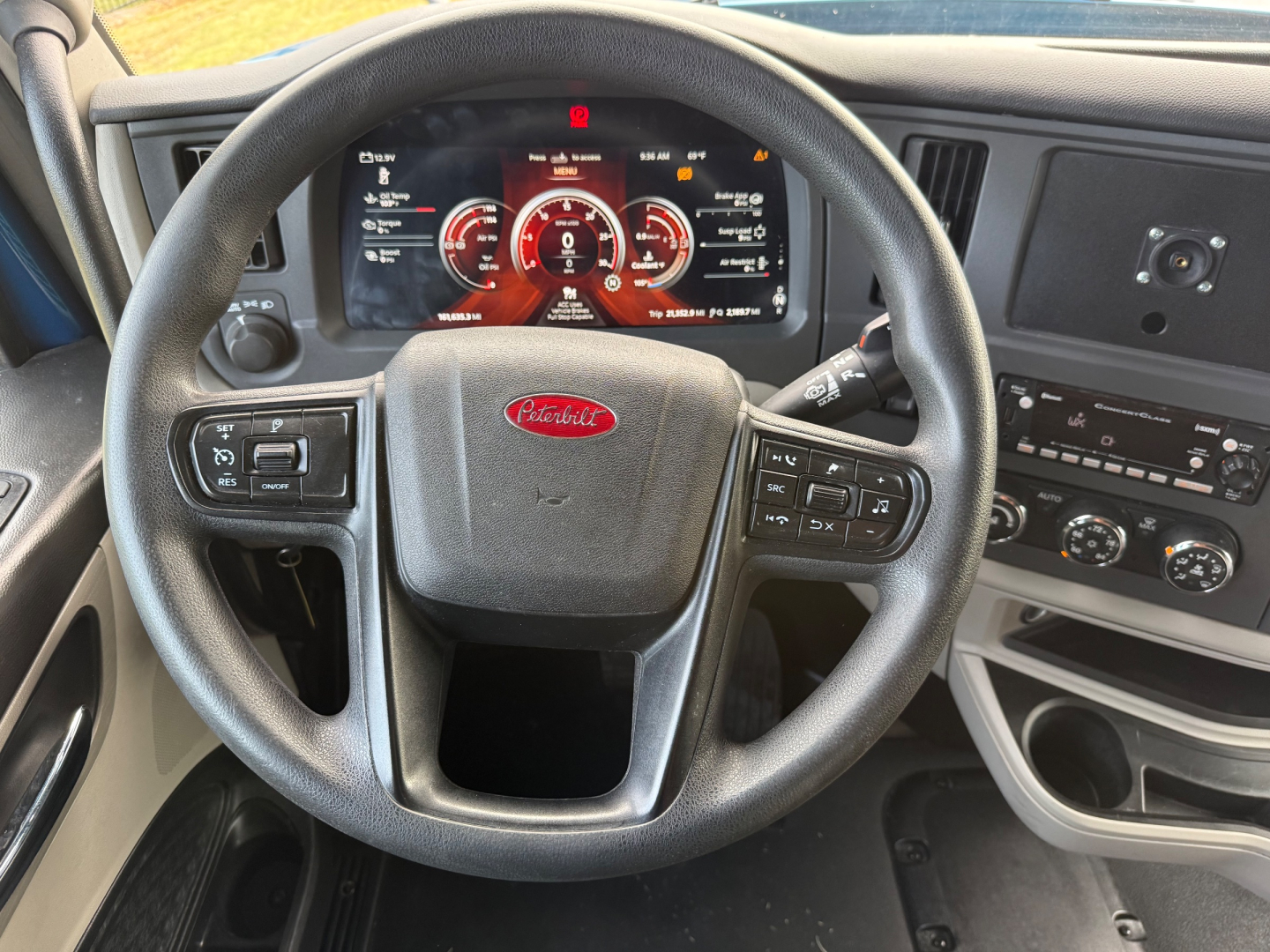 Peterbilt 579 steering wheel and dashboard view showing digital gauge cluster and center console controls.